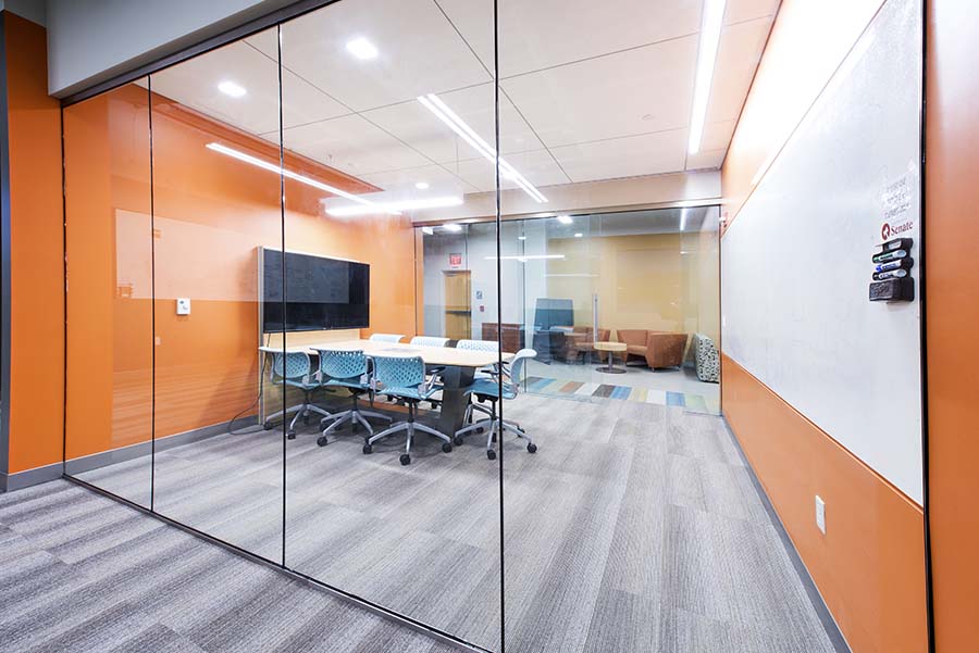 Photo of Tartan Collaborative Commons showing a conference room with TV and whiteboard